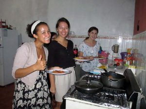 Four female spanish students prepare their dinners