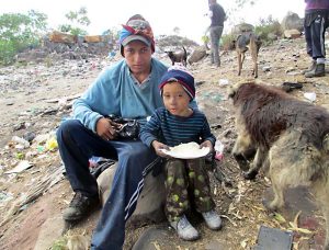 A young man and a little boy eating the lunch served by Spanish School Nicaragua
