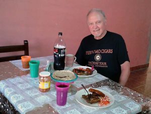 A man eating dinner at his Nicaraguan homestay Spanish immersion program