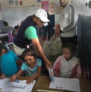 A Spanish students gives toothbrushes to local Nicaraguan students. Charities