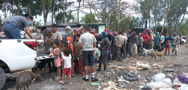 Scavengers lined up for lunch at the dump. Charity
