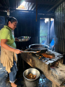 a woman cooking in a basic kitchen