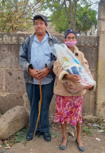 A blind man with a cane and his wife. Charity